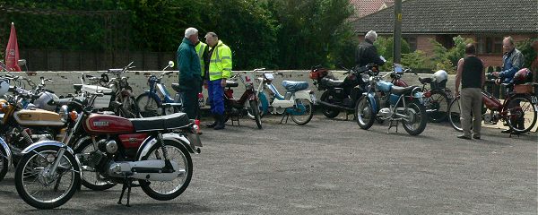 Bikes accumulate in the pub's car park