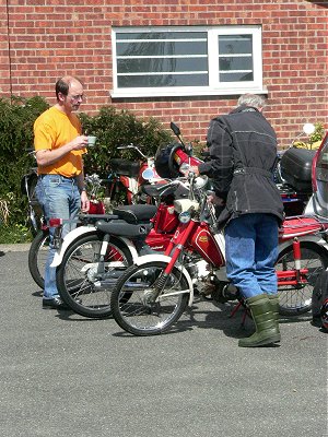 John Daborn checks his machine while Mike drinks tea and supervises