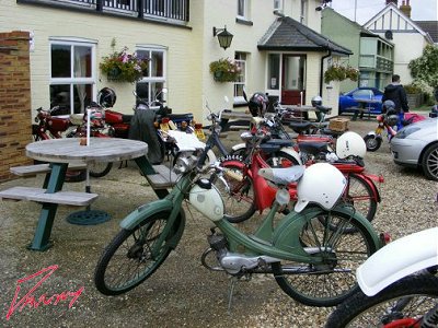 A line of mopeds leads to the door