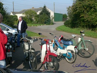 A few mopeds outside the hall
