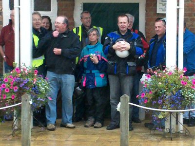 Sheltering from the rain - five minutes to opening time