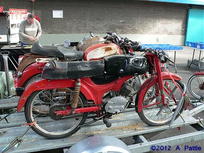 Three sports mopeds on a trailer