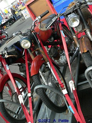 Three sports mopeds on a trailer