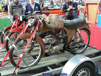 Three sports mopeds on a trailer