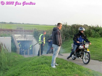 The underpass fills with blue smoke