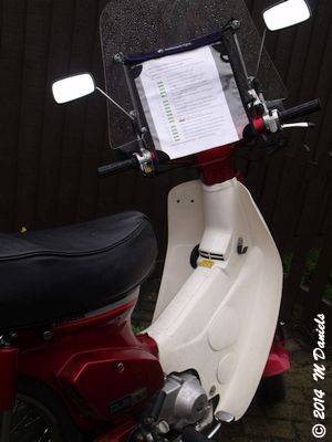 Handy route sheet holder on a Honda Cub